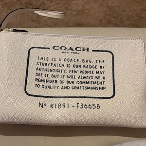Coach Cream Leather Wristlet with Black Text